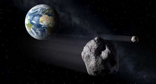 Астероид в космосе на фоне земли. Иллюстративное фото